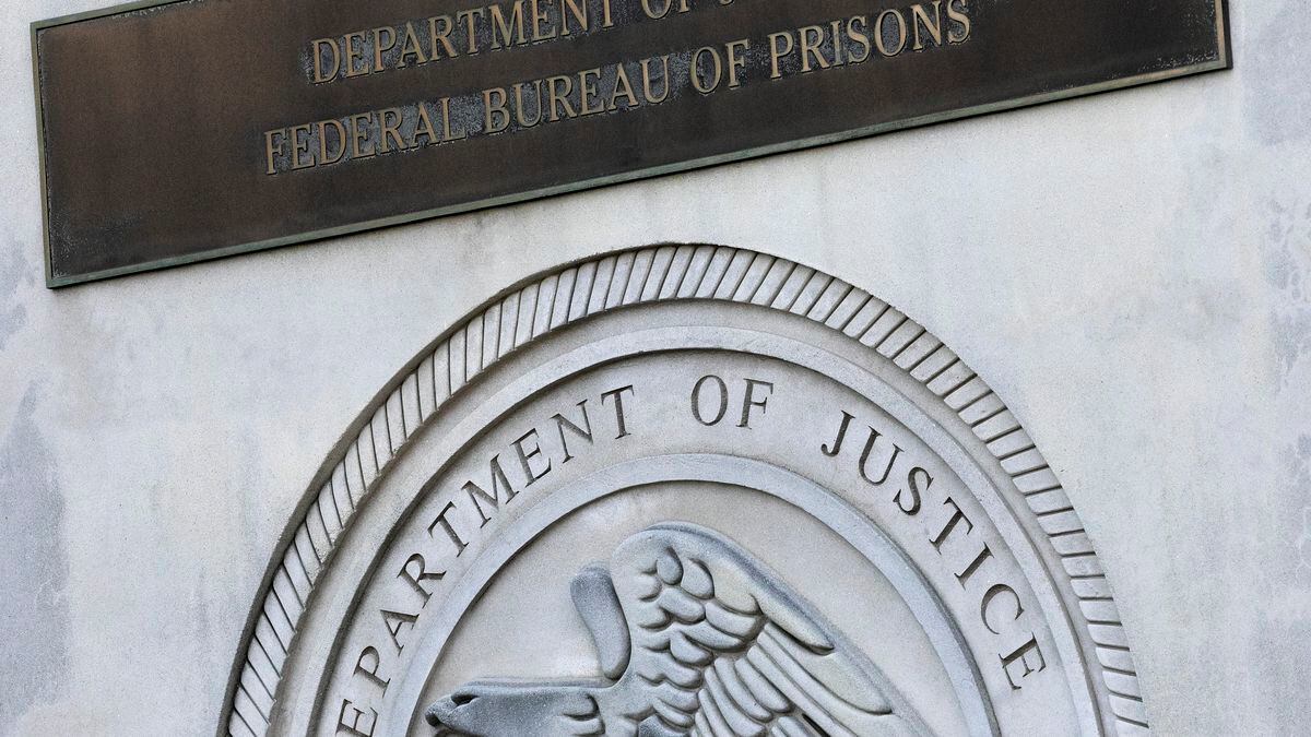 In this July 6, 2020, file photo a sign for the Department of Justice Federal Bureau of Prisons...