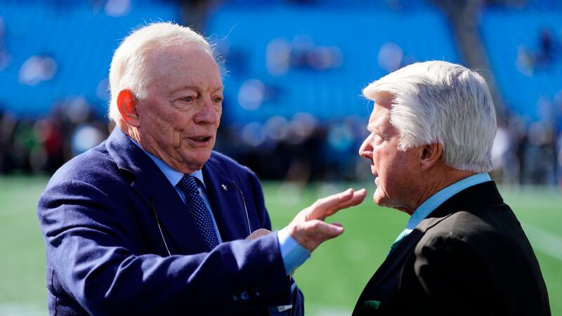 Dallas Cowboys owner Jerry Jones talks with former coach Jimmy Johnson before an NFL football...