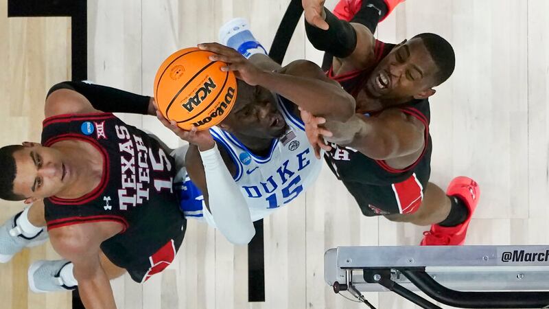Duke center Mark Williams, middle, shoots between Texas Tech guard Kevin McCullar Jr., left,...